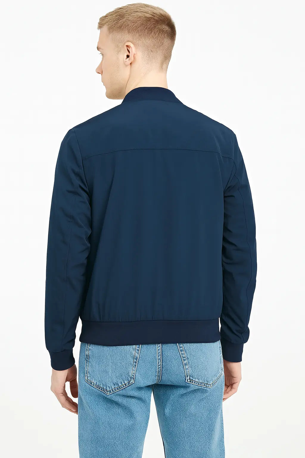 Back view of The Terminal List Chris Pratt blue bomber jacket with ribbed hem.